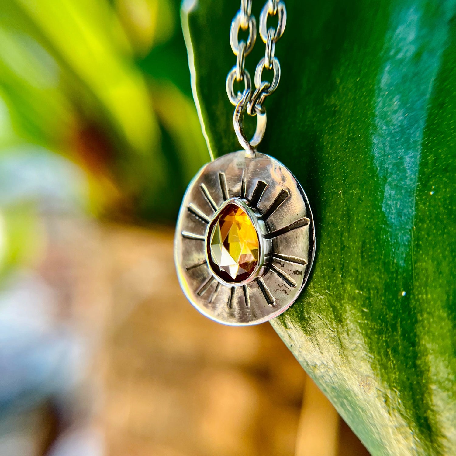 Sterling silver pendant, smoky crystal necklace, sun-inspired jewelry, boho chic accessory, handcrafted silver jewelry, artisan jewelry, nature-inspired jewelry.